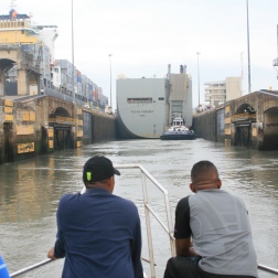 Entering the locks behind a large cargo ship